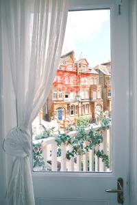 a window with a view of a building at Kensington 1B1B with Sofa Double Bed Max 4 Guests in London