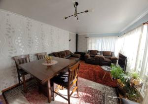 a living room with a table and a couch at Casa magallanica in Punta Arenas