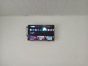 a tablet is hanging on a white wall at Departamentos Los dos Pinos in San José
