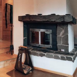a fireplace with a tv on top of it at Villa Polaris in Äkäslompolo +52 photos