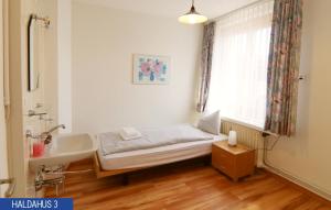 Postel nebo postele na pokoji v ubytování Haus Haldahus by Arosa Holiday + 22 fotografií