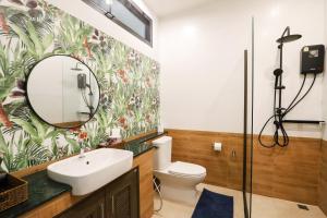 a bathroom with a sink and a mirror at Tiger House River Kwai in Ban Tha Thong Mon +88 photos