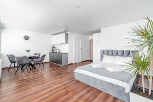 a bedroom with a bed and a table and chairs at MALŪNO Calm Getaway SELF CHECK-IN in Klaipėda