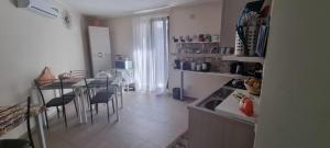 a kitchen with a counter and a table with chairs at La Regina Di Saba in Piazza Armerina +43 photos