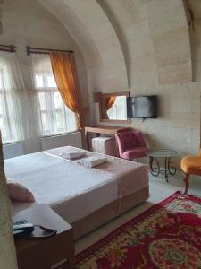 Postel nebo postele na pokoji v ubytování Mesken Cave Suites