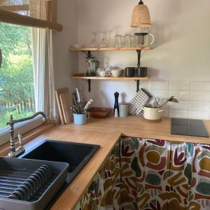 a kitchen with a sink and a counter top at Letnia Oficyna in Okoniny Polskie