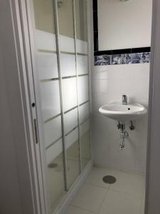 a bathroom with a glass shower and a sink at Villa Mon Bonheur in Altura +10 photos
