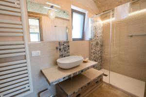 a bathroom with a sink and a shower at Resort Trulli San Leonardo in Alberobello
