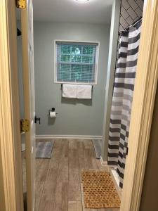 a bathroom with a shower and a window at 3BR, 2BA and Office Fire Pit,Mins 2 UConn & Lake in Coventry