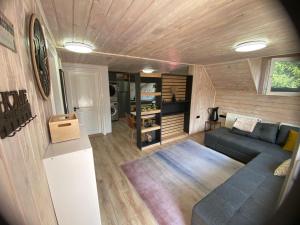 a living room with a blue couch in a tiny house at Vila Dani&Marina in Porumbacu de Sus