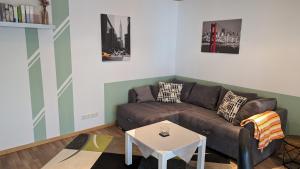 a living room with a couch and a table at Ferienwohnung Rumbeck in Hessisch Oldendorf