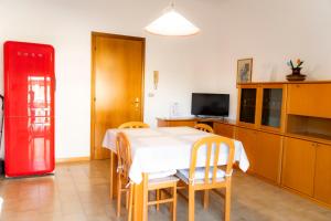 a kitchen with a table and chairs and a red refrigerator at Ampio appartamento in Mondolfo +41 photos