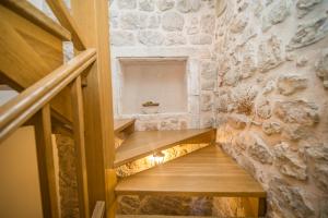 a staircase in a room with a stone wall at Vintage house Kolocep in Koločep +26 photos