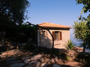 a stone house with a window on a stone wall at Villa Oraia Verga Kalamata in Kalamata
