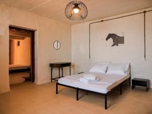 a room with a bed and a pendant light at Villa Oraia Verga Kalamata in Kalamata +23 photos