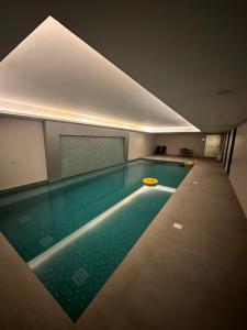 a swimming pool with a yellow frisbee in it at Pinnacle Row Comfort Corner in Muscat