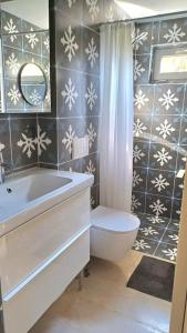 a bathroom with a tub and a toilet and a sink at quiet apartment near the sea in Athens