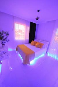 a bedroom with a bed with lights on it at Poseidon Marine Villa in Ildır +48 photos