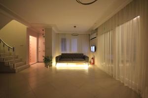 a living room with a couch and a staircase at Poseidon Marine Villa in Ildır