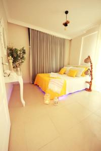 a bedroom with a bed with lights on the floor at Poseidon Marine Villa in Ildır