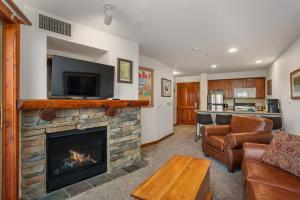 a living room with a fireplace with a flat screen tv at RF219 Hot tub,Heated garage and Parking in Snowshoe