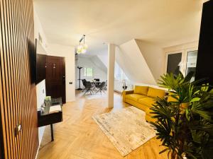 a living room with a yellow couch and a table at Ylly aparts in Braşov
