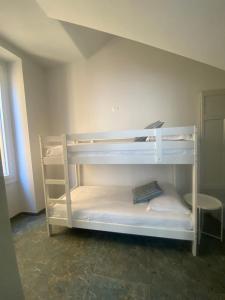 a white bunk bed in a room at Casa di Gilda in Ospedaletti