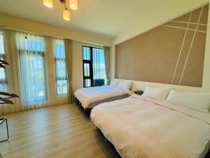 En eller flere senger på et rom på 宜蘭-讀好民宿 Read Nice House B&B 電梯民宿