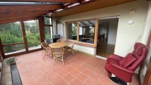 a screened in porch with a table and chairs at Holiday Apartment Erbach-Ulm in Erbach