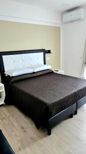 a bedroom with a bed with a black bed frame at Convenient Booking B&B in Rome