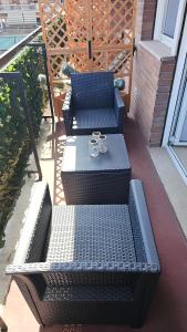 two chairs and a table on a patio with two glasses at Convenient Booking B&B in Rome +15 photos