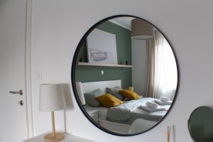 a bedroom with a bed and a mirror at Apartman Mali Muk, self check- in in Karlovac