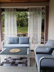 a living room with a couch and a window at Kuća za odmor Virtus Goč in Vrnjačka Banja