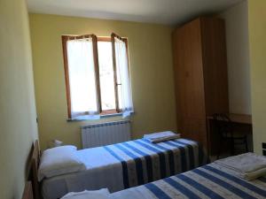 Postel nebo postele na pokoji v ubytování Valle del Poggio