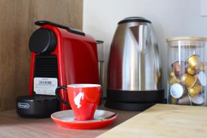 a coffee maker and a coffee cup on a counter at Apartman Mali Muk, self check- in in Karlovac