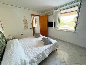 A bed or beds in a room at Exclusive Riverside House in the Center of Bosa - Private Garden and Parking" Bosa Apartments