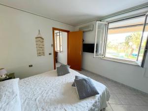 A bed or beds in a room at Exclusive Riverside House in the Center of Bosa - Private Garden and Parking" Bosa Apartments