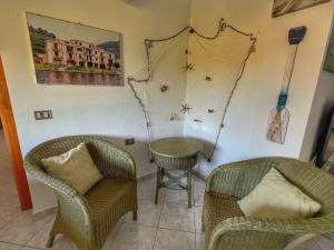 A seating area at Exclusive Riverside House in the Center of Bosa - Private Garden and Parking" Bosa Apartments