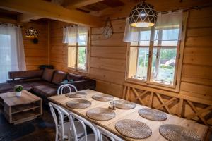 a room with a table with chairs and a couch at Chalupa JaRo in Bukovec