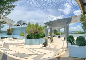 a pavilion with benches and plants on a patio at THE LOOP 2br fully furnished corner unit w balcony in Cagayan de Oro