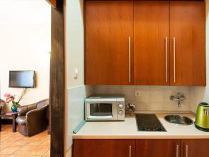 a kitchen with a microwave and a sink at Verdi Apartment in Belgrade