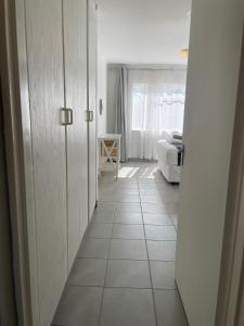 a hallway leading to a living room with a couch at Menlyn Place City Vibes in Pretoria