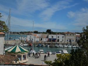 a group of boats are docked in a marina at Le Mole (Appartements et Chambres) in La Flotte +2 photos