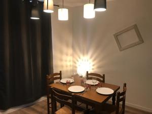 a dining room table with chairs and a light on the wall at Le gite 3 - Le Château du Lichtenberg in Sélestat +19 photos