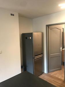 a kitchen with a stainless steel refrigerator in a room at Le gite 3 - Le Château du Lichtenberg in Sélestat