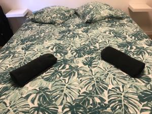 a bed with two black pillows on it at Le gite 3 - Le Château du Lichtenberg in Sélestat