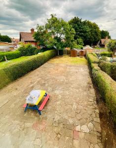 a bench sitting on top of a stone patio at Strelley house 4 , Perfect for business trip & Families holiday or working proffesionals-5 min from M1 J25 , 500MB Wi-Fi , Netflix , Fully equiped kitchen , Asda supermarket 5 min walk , Free Secure parking with CCTV ,available monthly deals in Nottingham