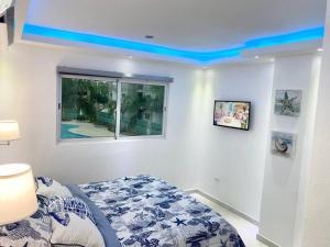 a bedroom with a bed with a blue ceiling at Beautiful and peaceful 2-bedroom family condo in Juan Dolio +34 photos