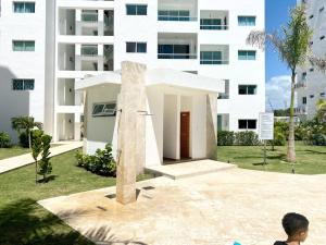 a boy is looking at a statue in front of a building at Beautiful and peaceful 2-bedroom family condo in Juan Dolio