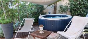 eine Terrasse mit zwei Stühlen und einem Whirlpool in der Unterkunft Villa Benvengudo in Villeneuve-lès-Avignon